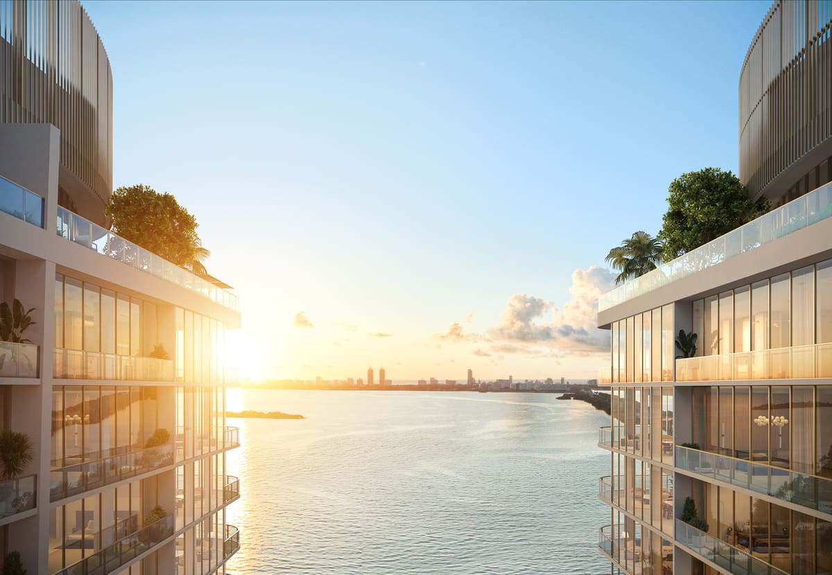 The curved balconies of Kempinski Residences Miami Design District at golden hour above Biscayne Bay