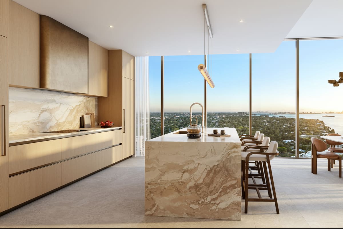 The natural stone waterfall island and stone wall cladding in a residence kitchen