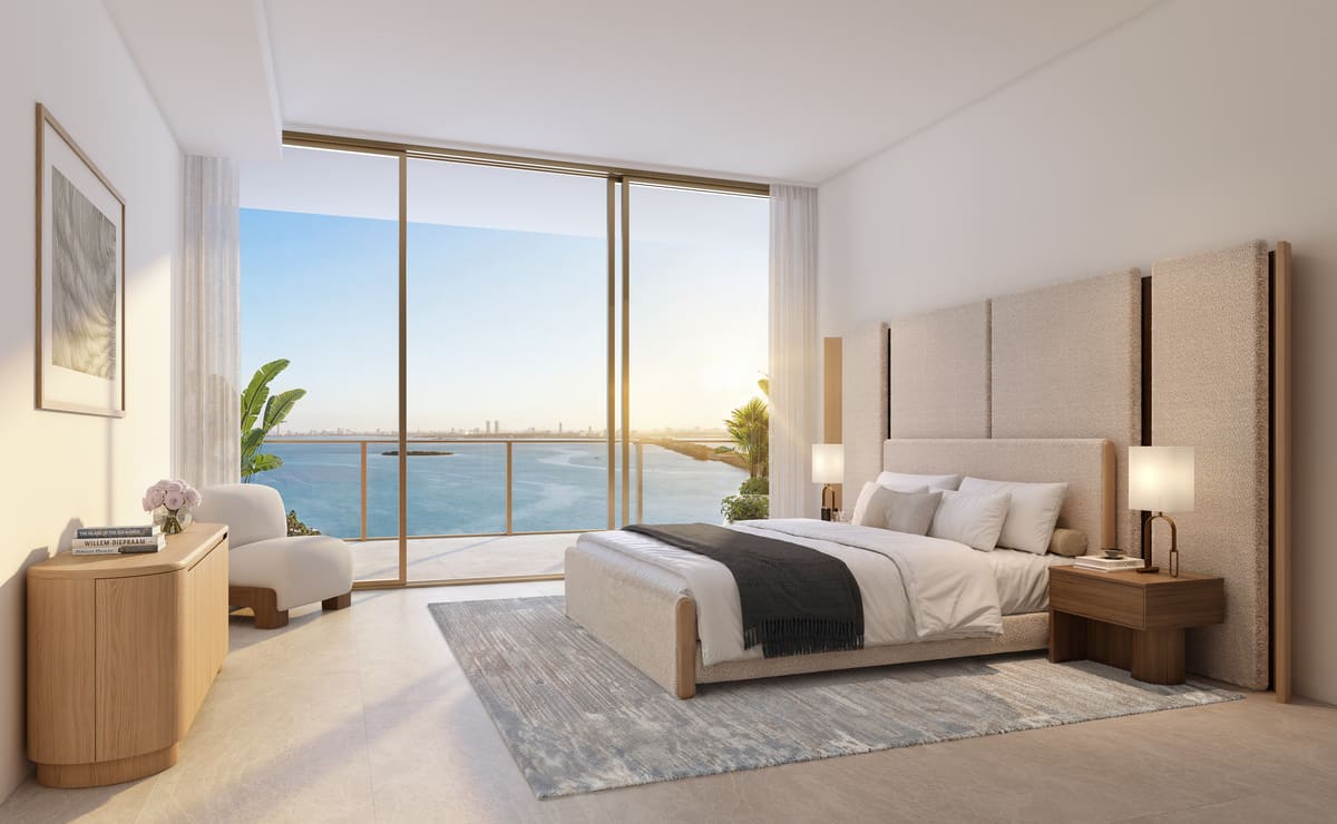 The primary bedroom of a residence, opening to a 10-foot-deep balcony above Biscayne Bay