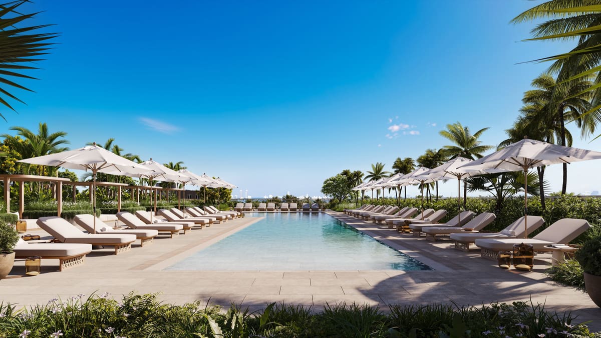 The South Tower pool deck with shaded loungers, umbrellas and palms above Biscayne Bay