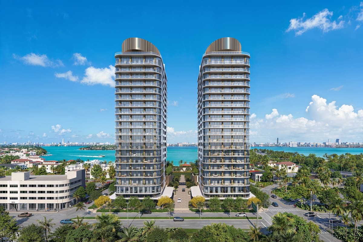 Kempinski Residences Miami Design District — the two 23-storey towers seen from Biscayne Boulevard with Biscayne Bay beyond